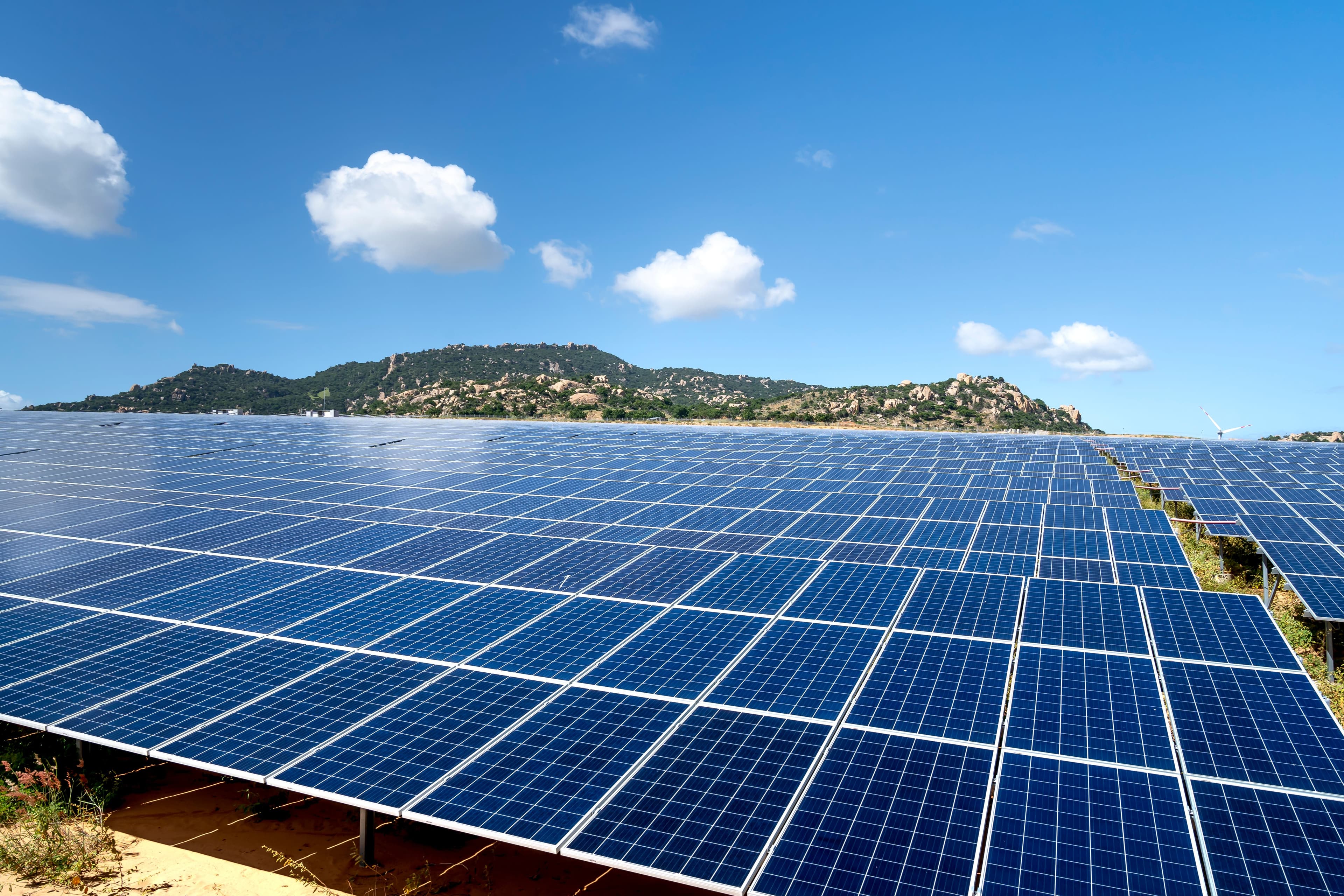 A wide array of panels below a rocky ridge